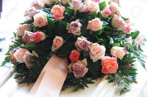 Ритуальный транспорт 10433838-pink-sympathy-flowers-with-a-pink-ribbon-on-a-white-coffin.jpg